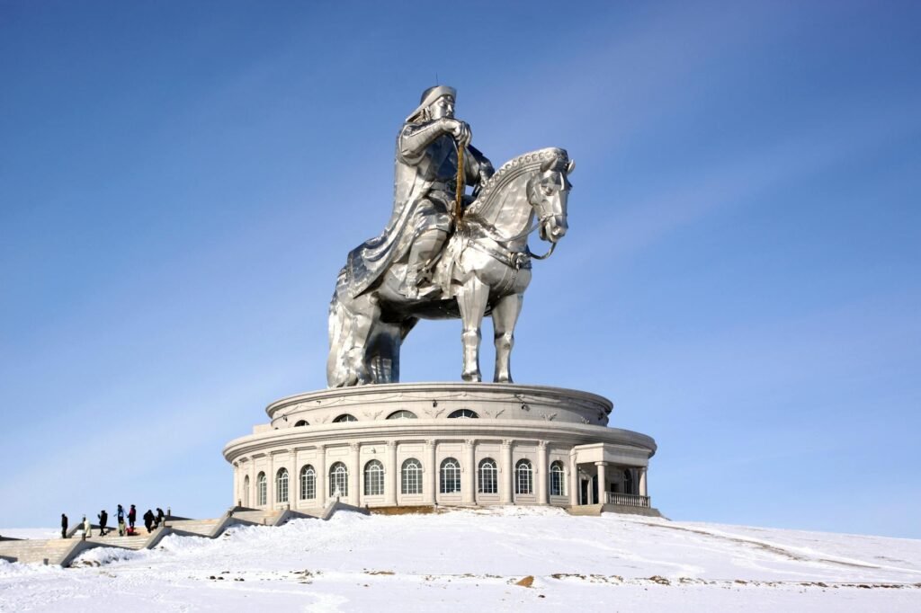 man riding a horse statue under blue sky